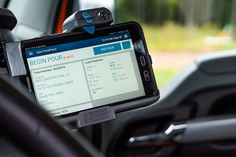 tablet inside the cab of a truck showing pour status